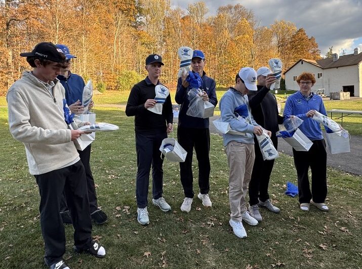 A high school golf team on the course, each player holding their custom headcovers